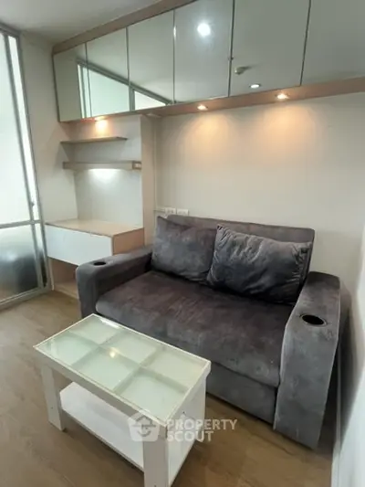 Cozy living room with plush gray sofa and modern glass coffee table
