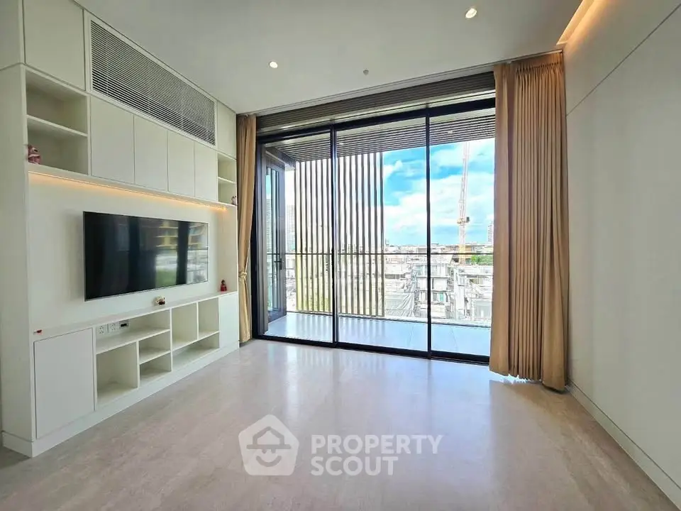 Spacious modern living room with floor-to-ceiling windows and city view