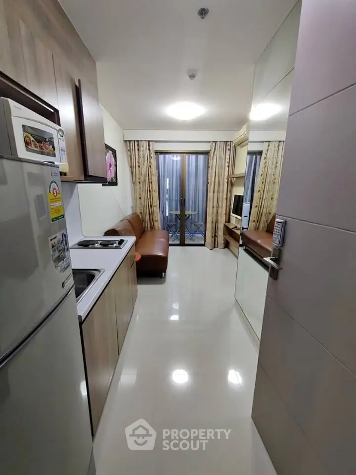 Modern compact kitchen with open layout and cozy living area