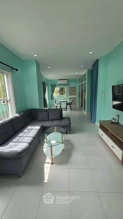 Spacious living room with modern decor and large windows in a stylish home