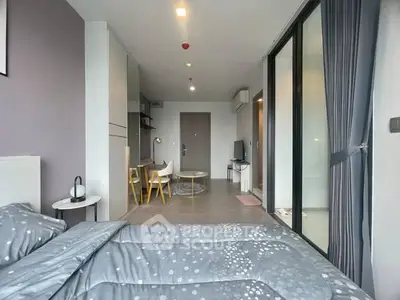 Modern bedroom with stylish decor and open layout, featuring a cozy bed and elegant furniture.