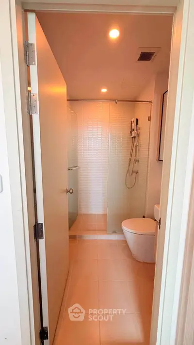 Modern bathroom with sleek shower and contemporary fixtures in a stylish apartment.