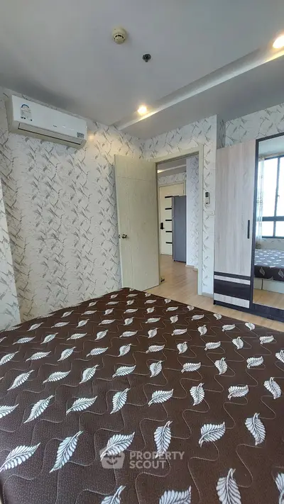 Spacious bedroom with modern decor and ample natural light