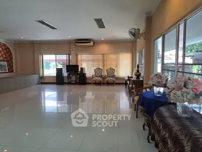 Spacious living room with elegant decor and large windows offering natural light.