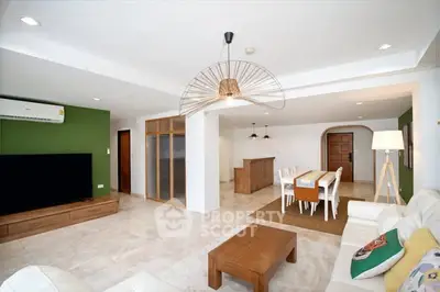 Spacious modern living room with open dining area, stylish lighting, and elegant decor.