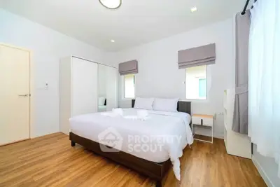 Spacious bedroom with modern decor and natural light