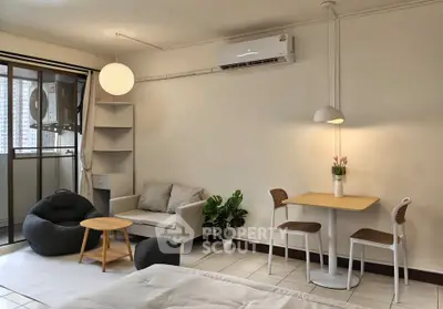 Cozy studio apartment with modern furnishings and balcony view