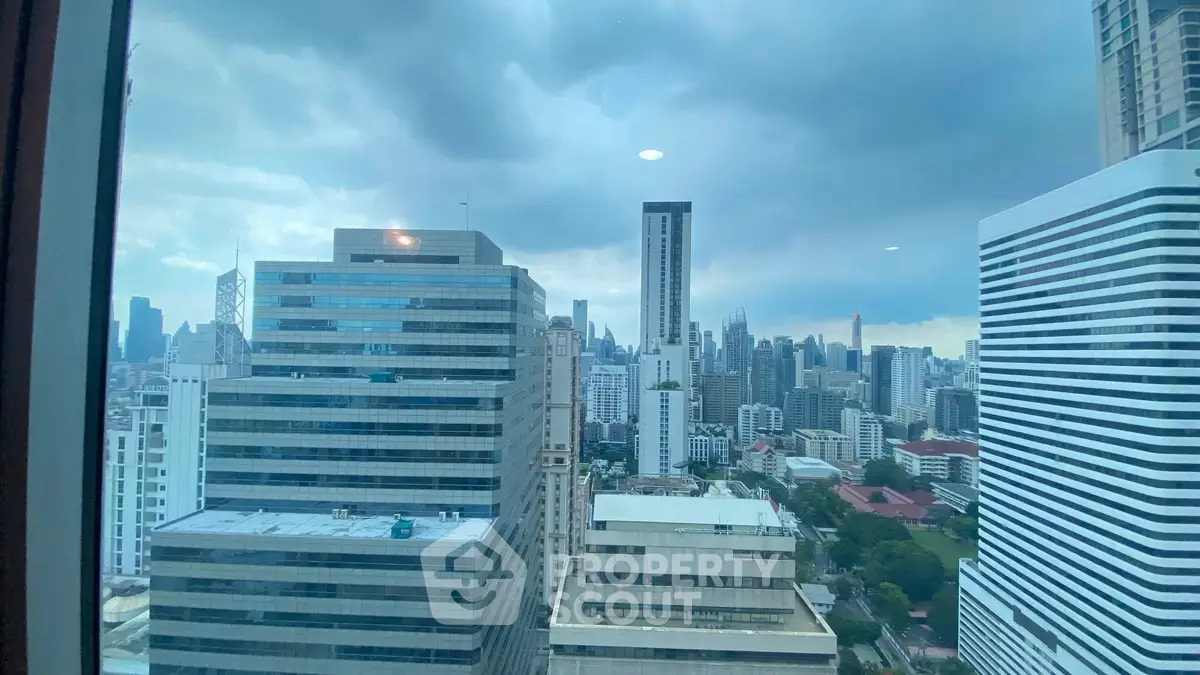 Stunning cityscape view from high-rise building window showcasing urban skyline.