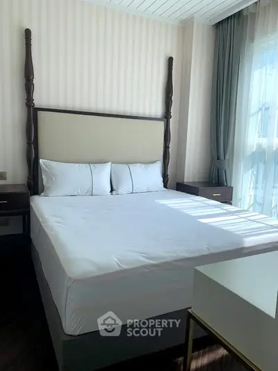 Elegant bedroom with natural light and stylish furnishings in a modern apartment.