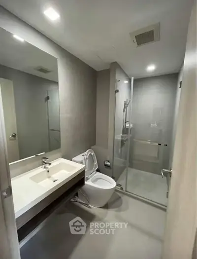 Modern bathroom with sleek fixtures and glass shower enclosure