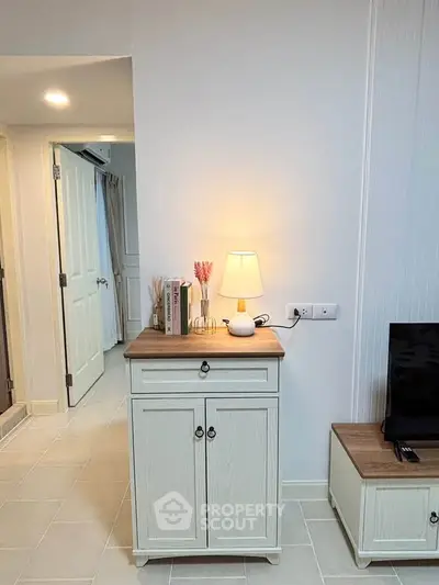 Cozy interior with stylish cabinet and warm lighting, perfect for modern living spaces.