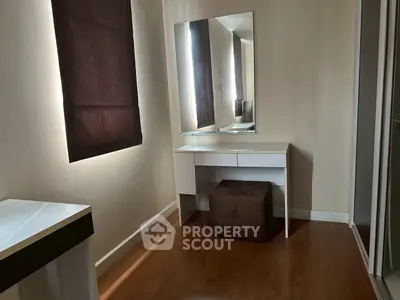 Cozy study nook with mirror and natural light, perfect for focused work or makeup application.