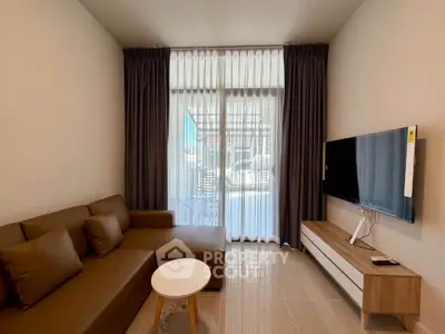 Modern living room with sleek furniture and large window for natural light.