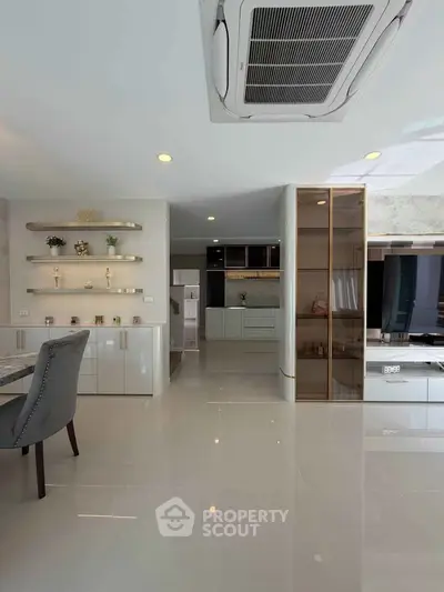 Modern open-plan living area with sleek kitchen and elegant dining space.
