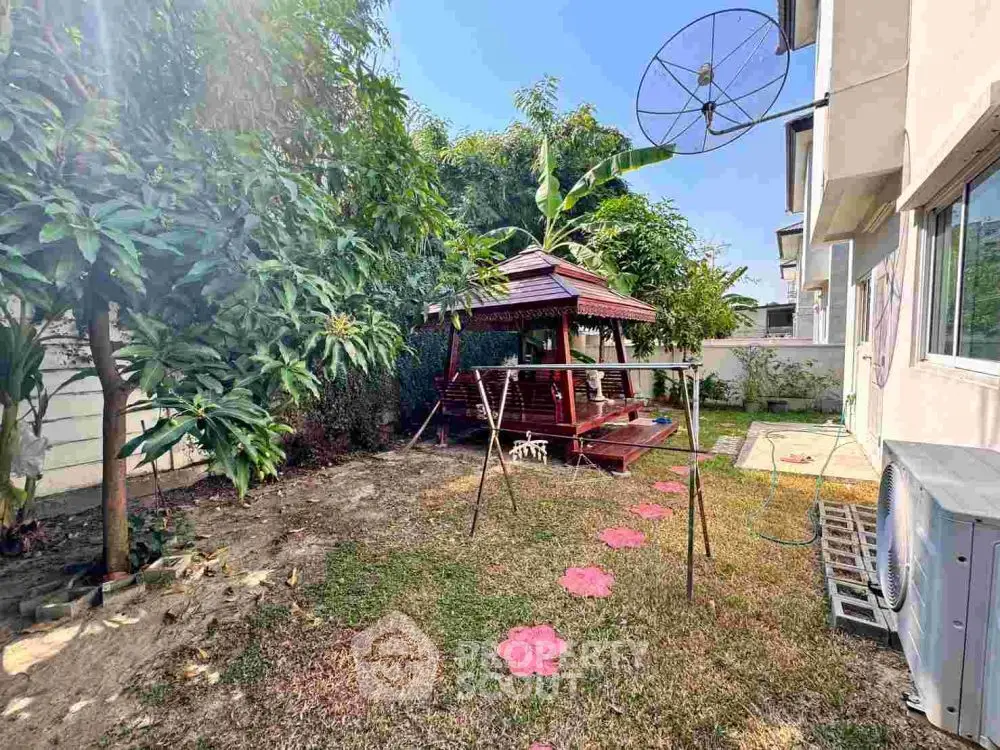 Charming backyard with gazebo and lush greenery, perfect for relaxation and outdoor activities.