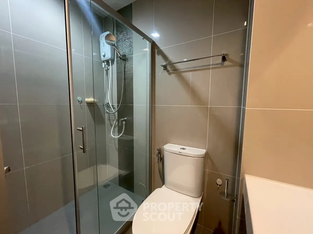 Modern bathroom with glass shower enclosure and sleek fixtures