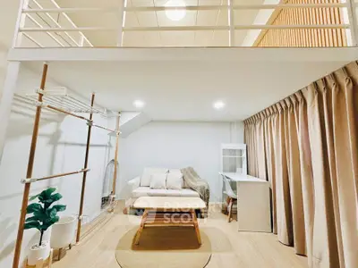 Modern loft-style living room with cozy seating and natural light