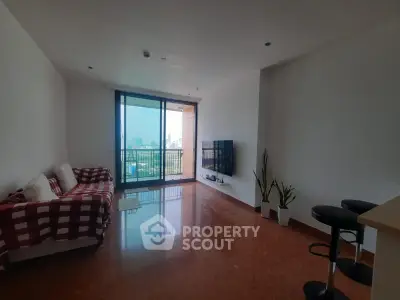 Spacious living room with city view and modern decor in high-rise apartment.