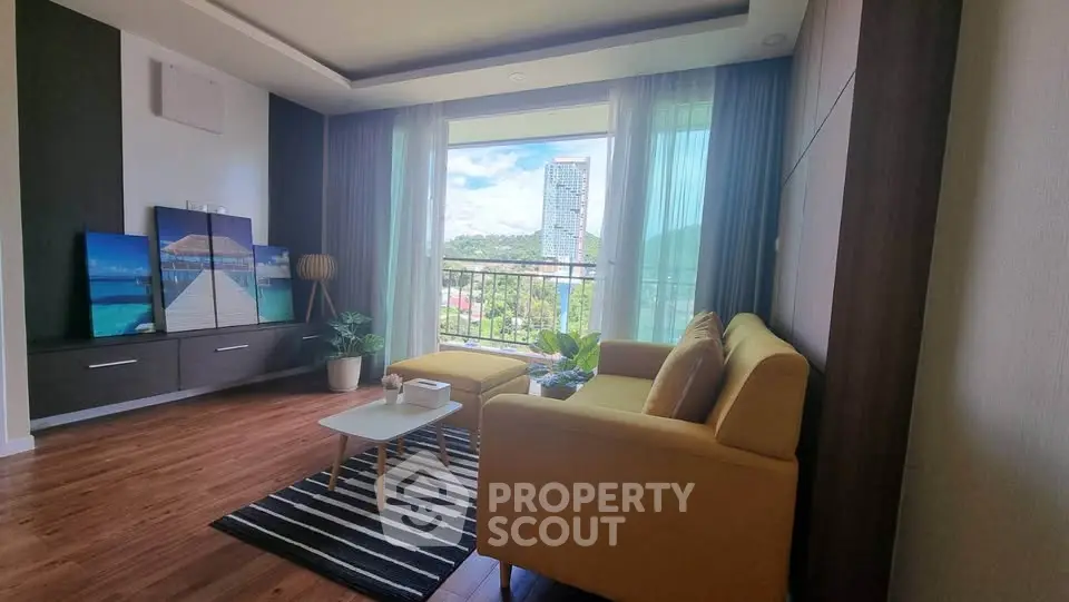 Spacious living room with modern decor and stunning view of cityscape through large window.