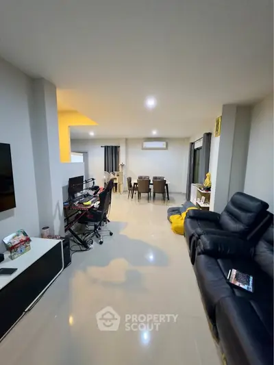Spacious modern living room with sleek furniture and open layout, perfect for family gatherings.