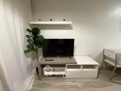 Modern living room with sleek TV stand, minimalist decor, and stylish flooring.