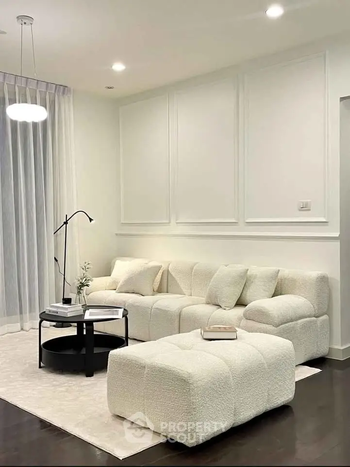 Elegant modern living room with plush white sofa and stylish decor