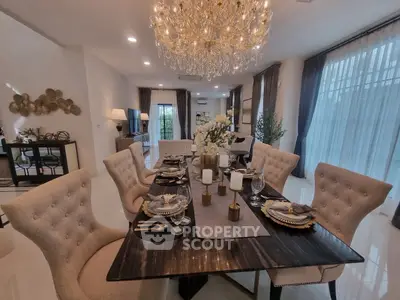 Luxurious dining room with elegant chandelier and stylish decor in a modern home.