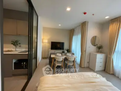 Modern studio apartment with open layout, featuring a cozy dining area and sleek kitchen.