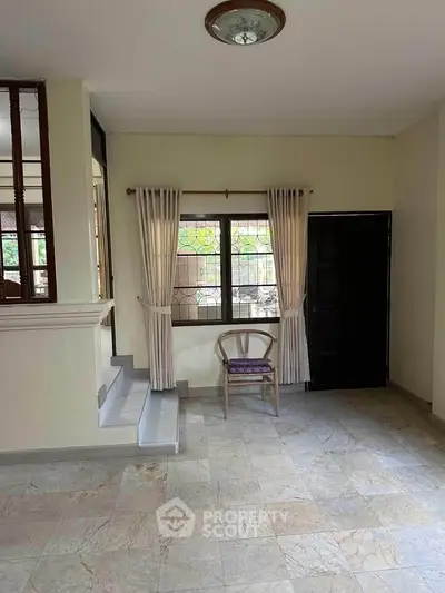 Spacious interior with tiled flooring and natural light, perfect for cozy living.