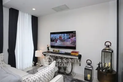Modern living room with stylish decor and wall-mounted TV