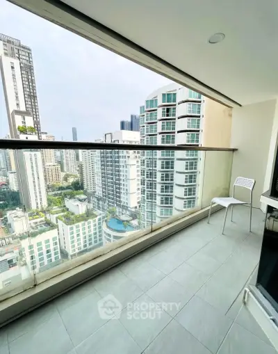 Spacious balcony with stunning city view in modern high-rise apartment.