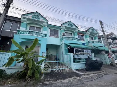 Charming turquoise townhouse with balcony and garden in a serene neighborhood