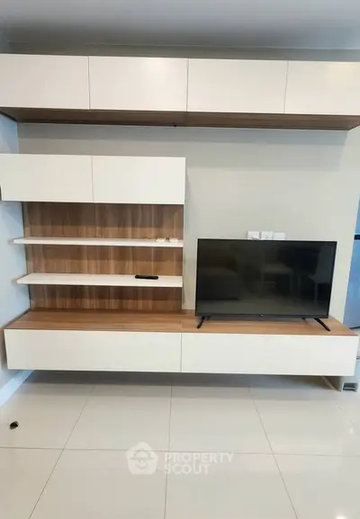 Modern living room with sleek TV unit and stylish shelving, perfect for contemporary home design.