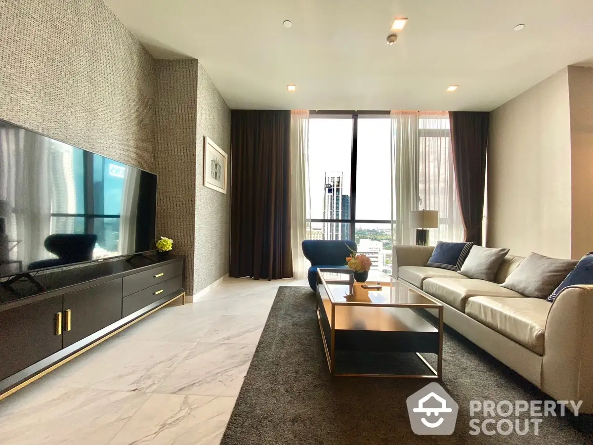 Elegant living room with plush seating, modern entertainment unit, and floor-to-ceiling windows offering an urban view.