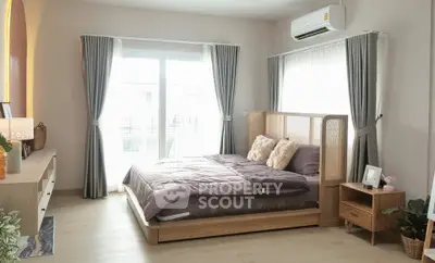 Spacious bedroom with modern decor and natural light