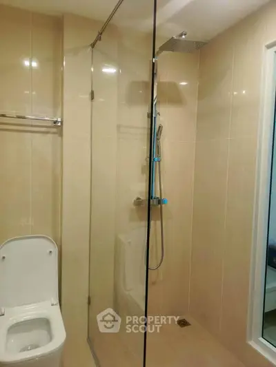 Modern bathroom with glass shower enclosure and sleek fixtures