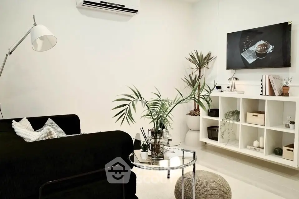 Modern living room with sleek black sofa and stylish decor