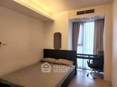 Modern bedroom with study area and large window in stylish apartment