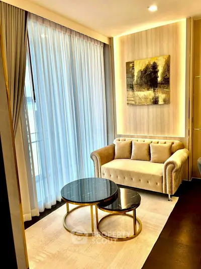 Elegant living room with plush sofa, stylish coffee tables, and floor-to-ceiling curtains.