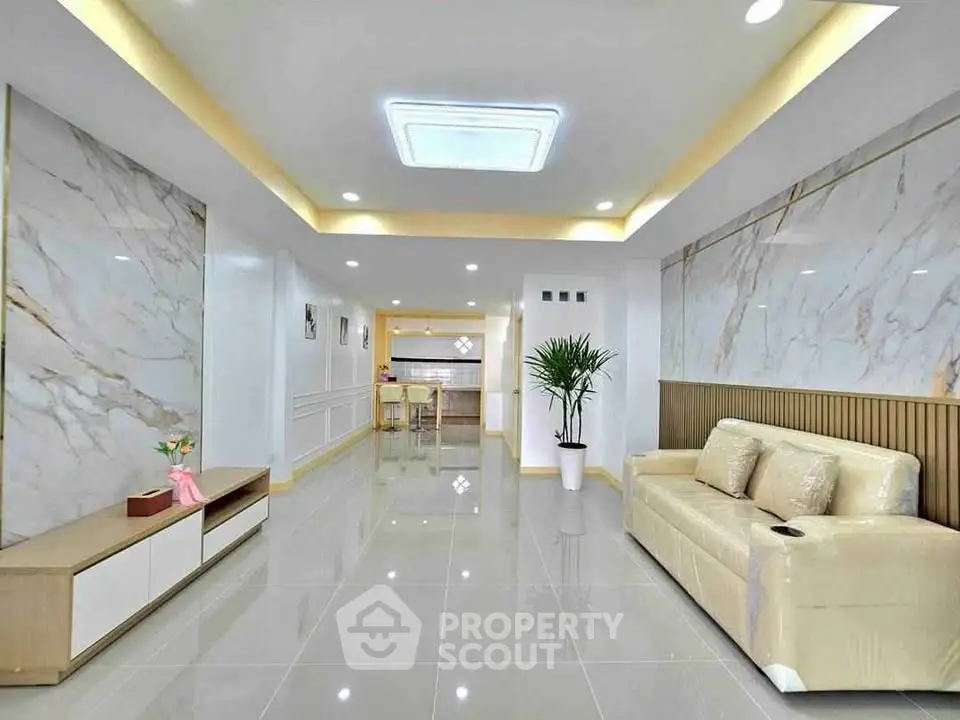 Spacious modern living room with elegant marble accents and sleek furniture