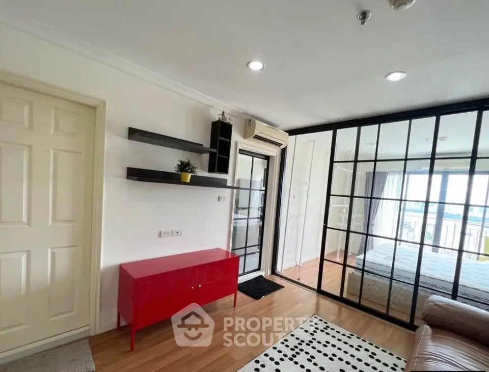 Modern apartment interior with glass partition, stylish shelves, and cozy bedroom view.