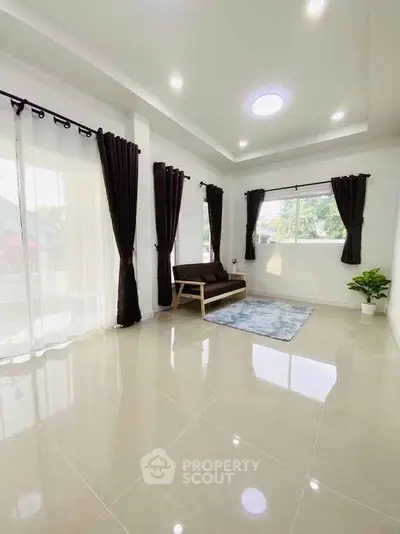 Spacious living room with modern decor and large windows for natural light.