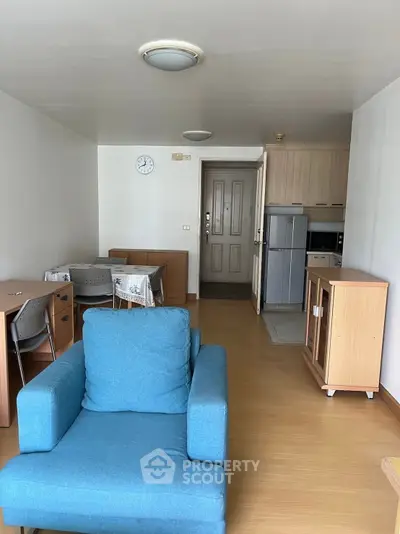 Cozy living room with modern furniture and open kitchen layout in a stylish apartment.