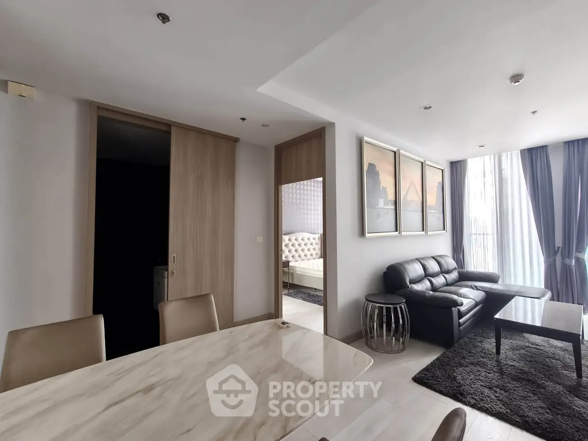Modern living room with elegant decor and natural light in a stylish apartment.
