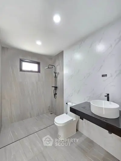Modern minimalist bathroom with sleek fixtures and elegant tile design