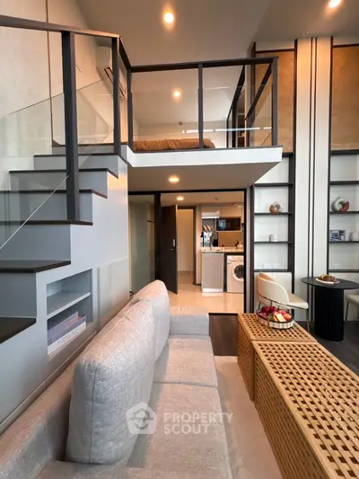 Modern loft apartment with stylish mezzanine bedroom and open living area, featuring sleek staircase and contemporary decor.