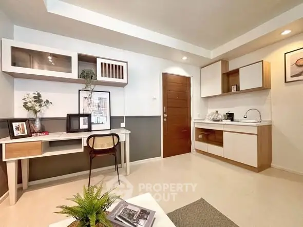 Modern living room with stylish furniture and compact kitchen area, perfect for urban living.
