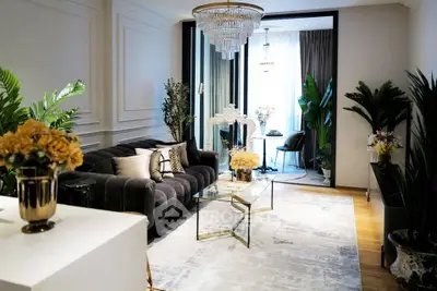 Luxurious living room with elegant decor and plush seating in a modern apartment.