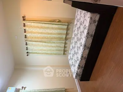 Spacious bedroom with elegant curtains and wooden flooring