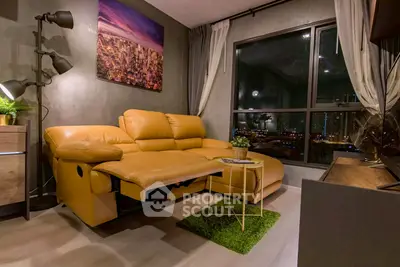 Modern living room with yellow sofa and city view window at night.